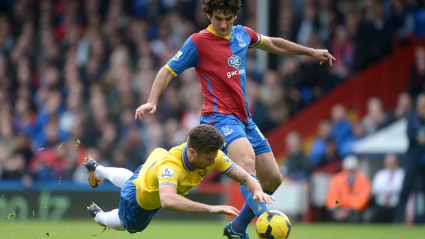 Arsenal's Olivier Giroud (left) goes to ground after battling for the ball with Crystal Palace's Mile Jedinak (right)