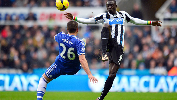 Chelsea John Terry  and Newcastle United Papiss Cisse battle for the ball